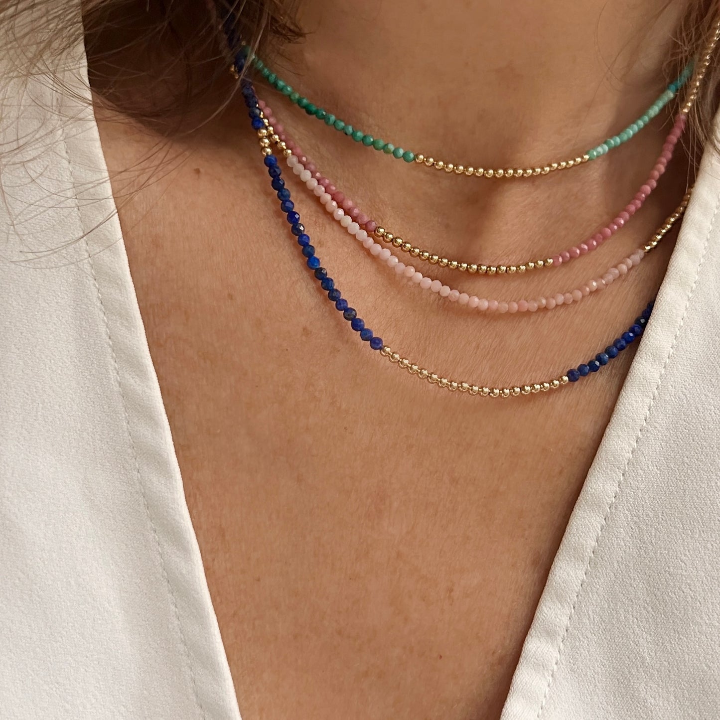 Faceted rhodonite and 14K gold bead necklace, featuring natural pink hues and a secure lobster clasp for comfortable, everyday wear.