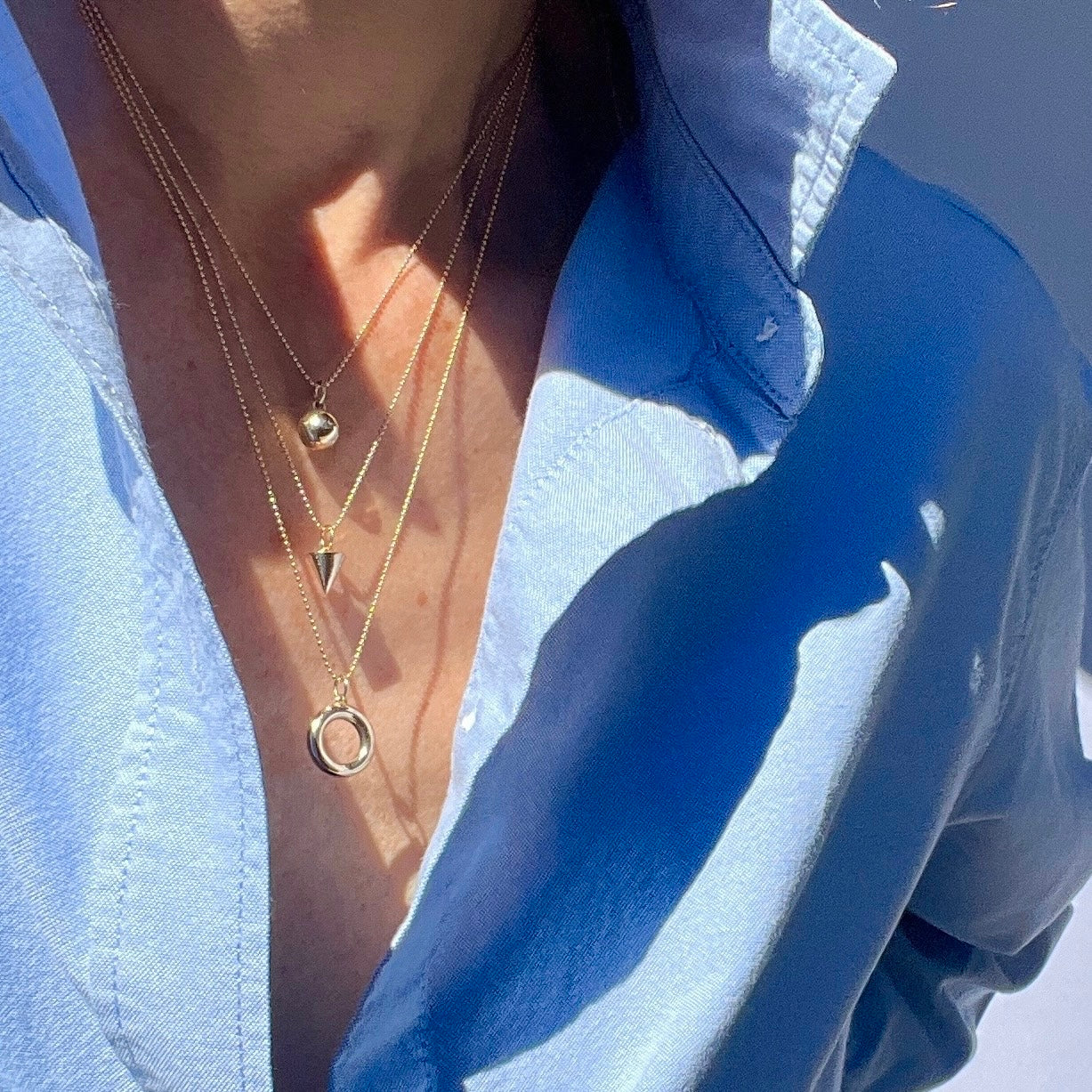The Zenith Petite Necklace channels energy through its triangle cone shape, symbolizing the harmonious balance of life. Available in solid 14K gold or sterling silver, it’s perfect for any jewelry collection.