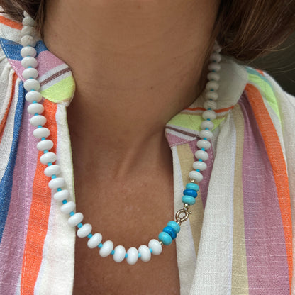 A stylish necklace with white onyx, turquoise, and howlite beads, finished with a premium 14k gold or sterling silver clasp.