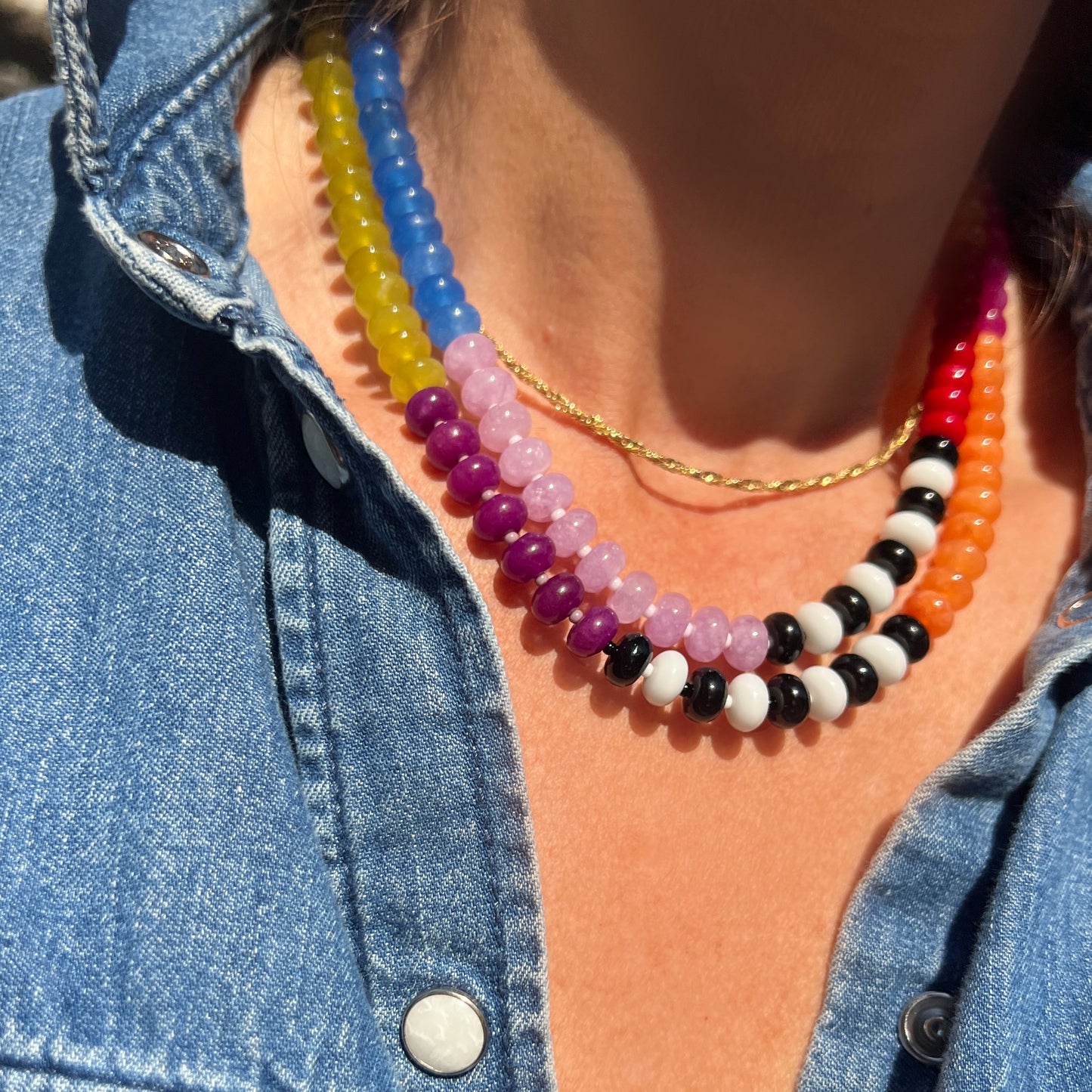 A striking, colorful necklace made with 8mm jade, onyx, chalcedony, and Czech glass beads, perfect for adding a pop of color to any outfit.