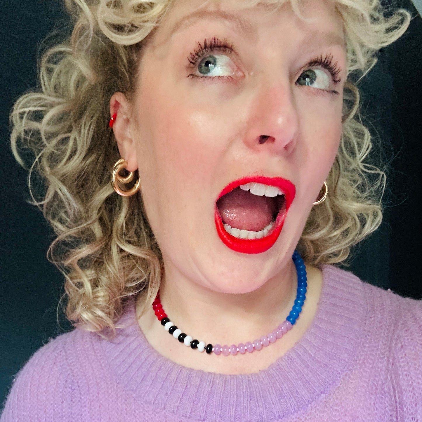 A model wearing a vibrant necklace featuring 8mm jade, onyx, and chalcedony gemstones with colorful Czech glass bead spacers.