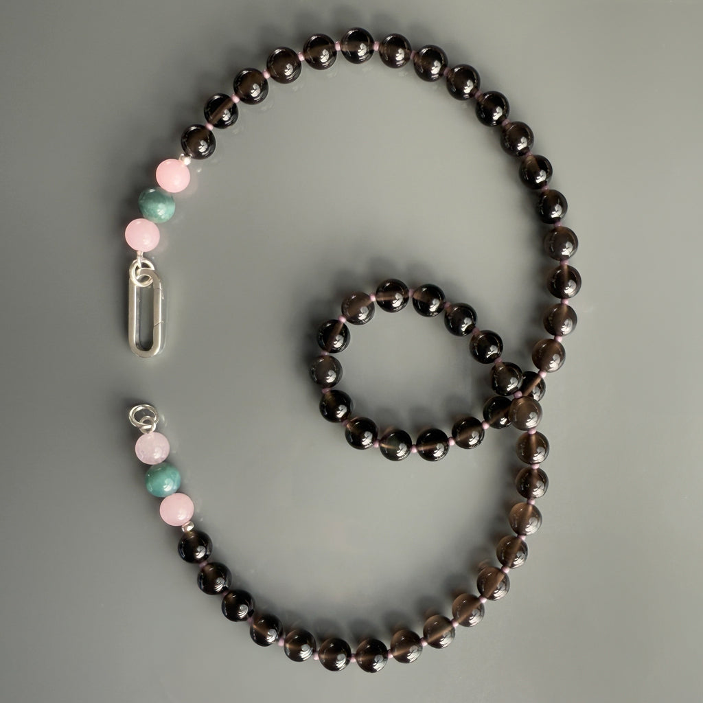 This handmade Natural Gemstone Beaded Necklace features Obsidian, Pink Quartz, and Agate, with a 14K gold or sterling silver clasp, perfect for layering or personalizing with a charm.