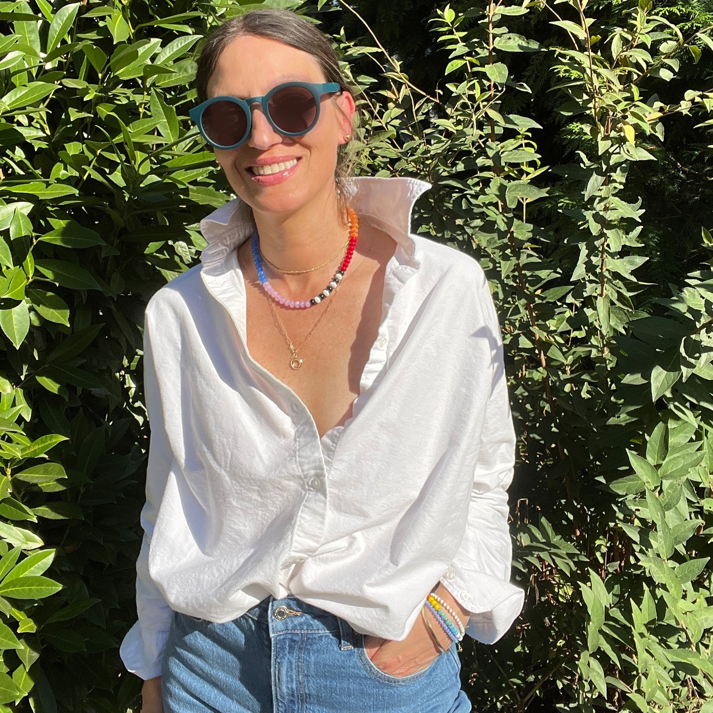 A handcrafted gemstone necklace worn by a model, highlighting its dynamic colors and elegant design.