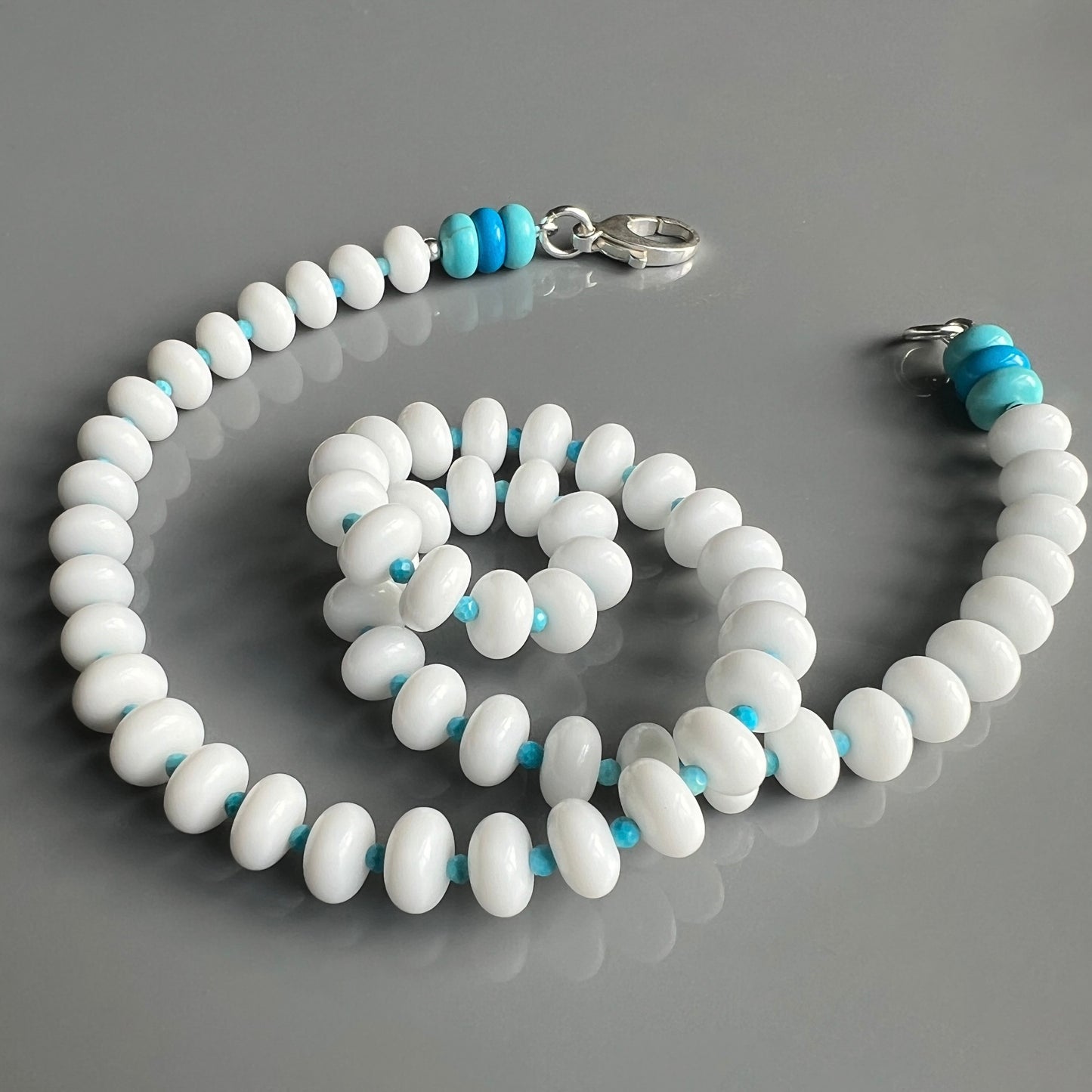 A versatile necklace featuring white onyx and turquoise, perfect for adding a pop of color to both casual and beachwear outfits.