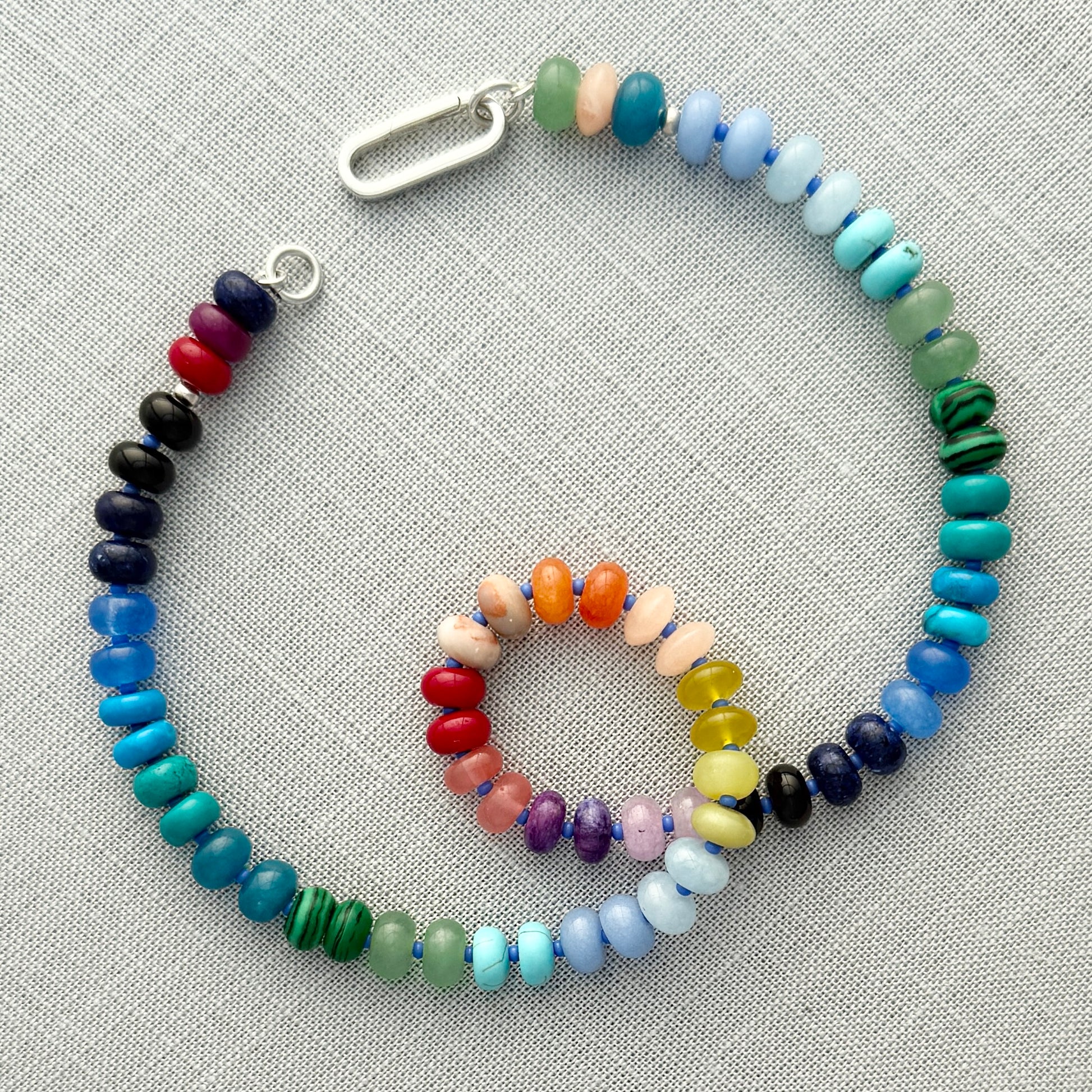 Vibrant handcrafted gemstone necklace with 8mm opals, jade, turquoise, and more, accented with Czech glass beads and a sterling silver clasp, perfect for layering or standalone wear.