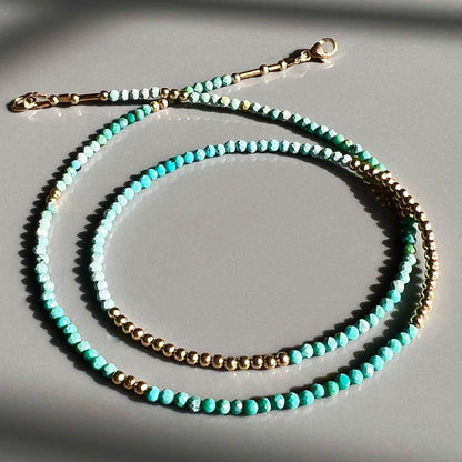 Elegant faceted turquoise and 14K gold bead necklace, perfect for adding a touch of subtle luxury to any outfit.