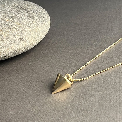 The Zenith Petite Necklace features a short triangle charm symbolizing strength, unity, and growth. Crafted in solid 14K gold or sterling silver, it channels energy and embodies balance.