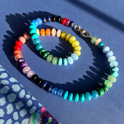 Handcrafted gemstone necklace with 8mm opals, jade, turquoise, and more, accented with Czech glass beads and a sterling silver clasp, perfect for layering or a bold solo look.