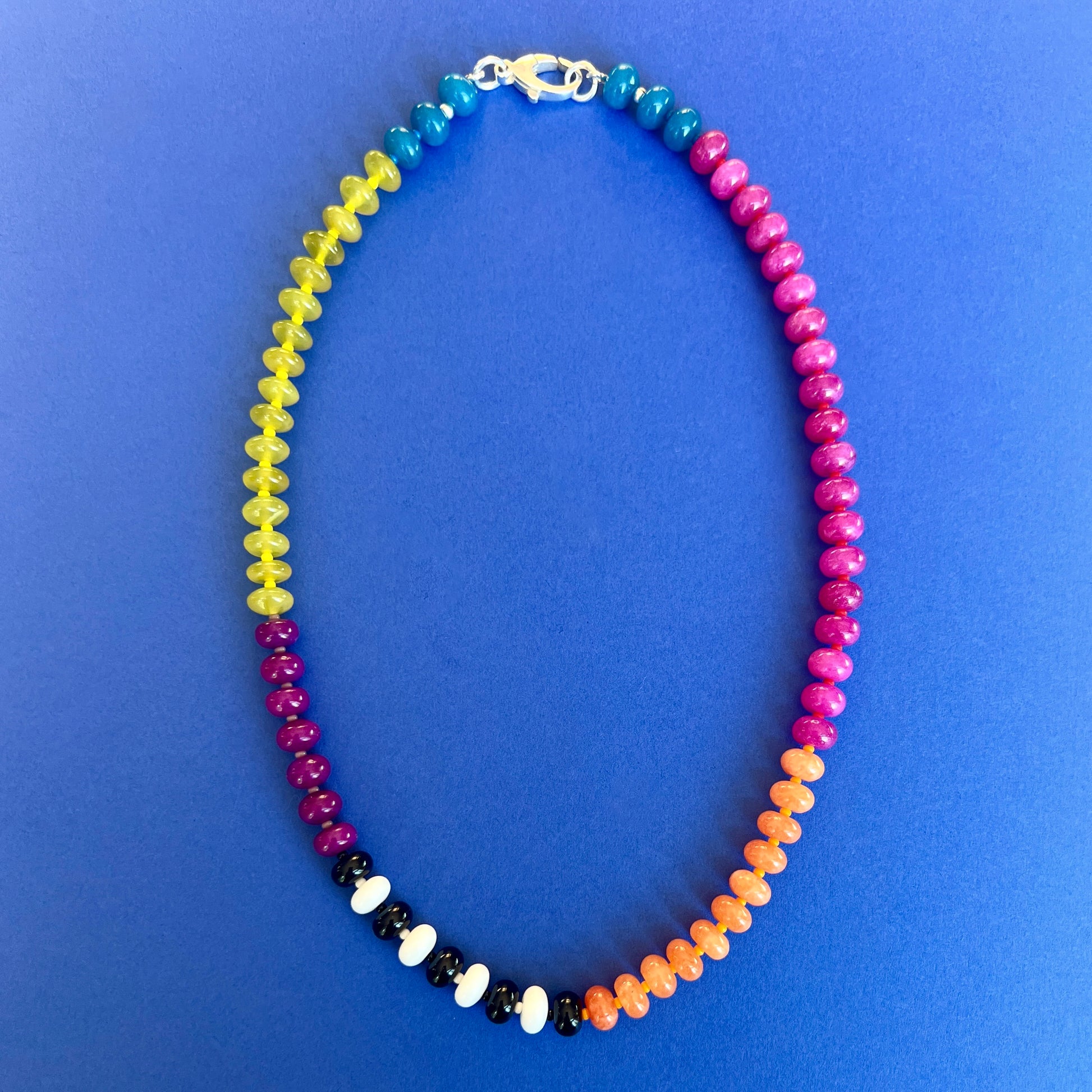 A colorful necklace with 8mm jade, onyx, and chalcedony gemstones, accented with bold Czech glass beads and a premium clasp.