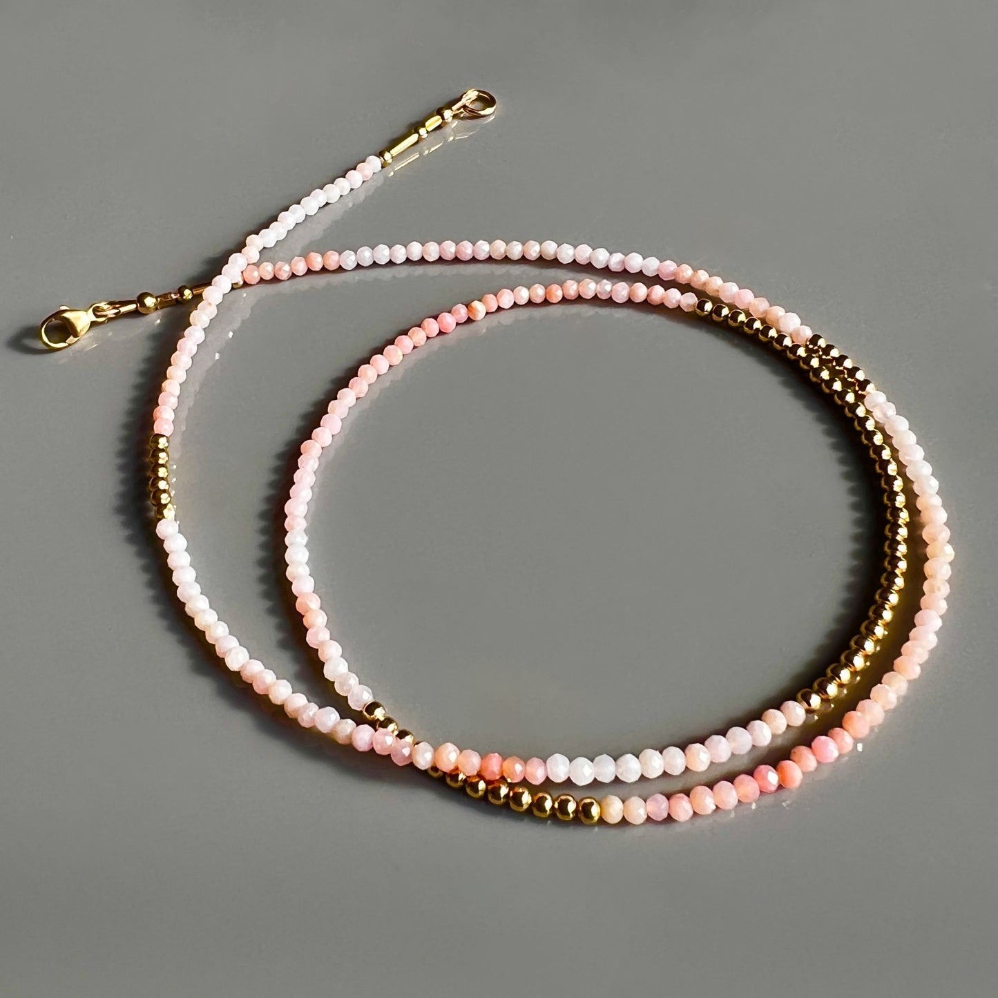 Elegant faceted pink opal and 14K gold beaded necklace, perfect for a graceful solo look or layered for a unique, trend-setting style.
