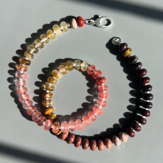 A handcrafted Desert Rose Necklace featuring rhodonite, jasper, quartz, and coral gemstones, finished with a 14k gold or sterling silver clasp. 