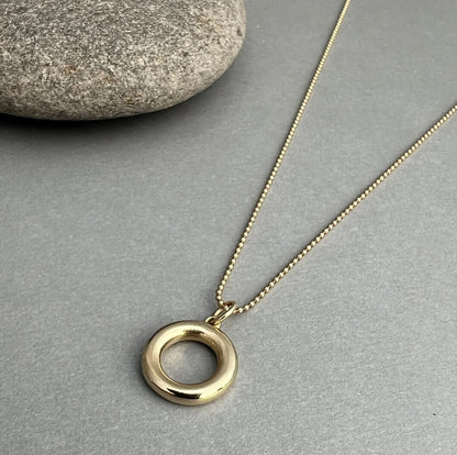 The 14K Gold Circle Necklace symbolizes unity, balance, and strength. Crafted from solid 14K gold, its minimalist design serves as a timeless reminder to stay grounded.