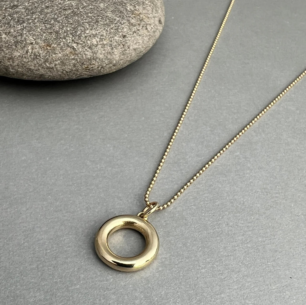 The 14K Gold Circle Necklace symbolizes unity, balance, and strength. Crafted from solid 14K gold, its minimalist design serves as a timeless reminder to stay grounded.