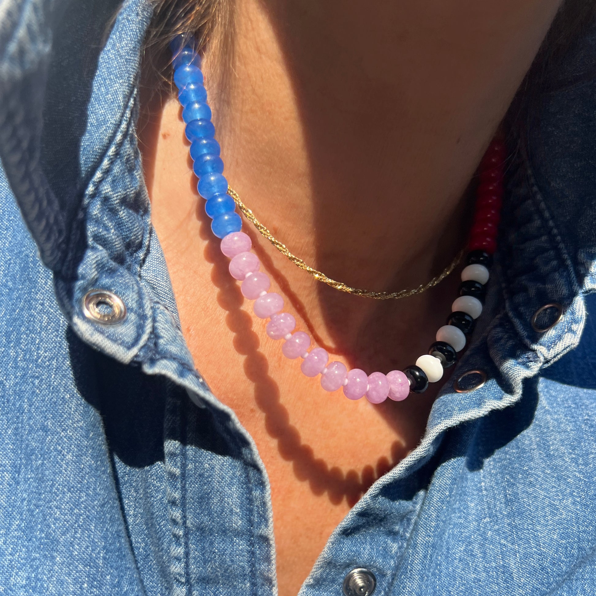 A statement necklace featuring jade, onyx, chalcedony, and Czech glass beads with premium silver findings.