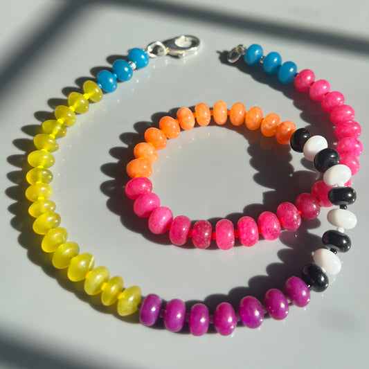 A handcrafted necklace featuring a mix of jade, onyx, and chalcedony gemstones with Czech glass bead spacers, available with a sterling silver clasp.