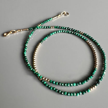 Exquisite faceted malachite gemstone necklace with 14K yellow gold beads, designed for timeless elegance and versatile styling.