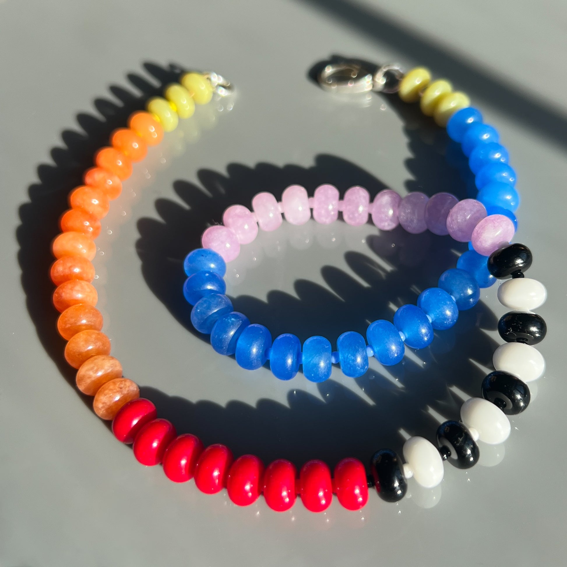 A bold necklace featuring 8mm jade, onyx, and chalcedony gemstones with vibrant Czech glass bead spacers.