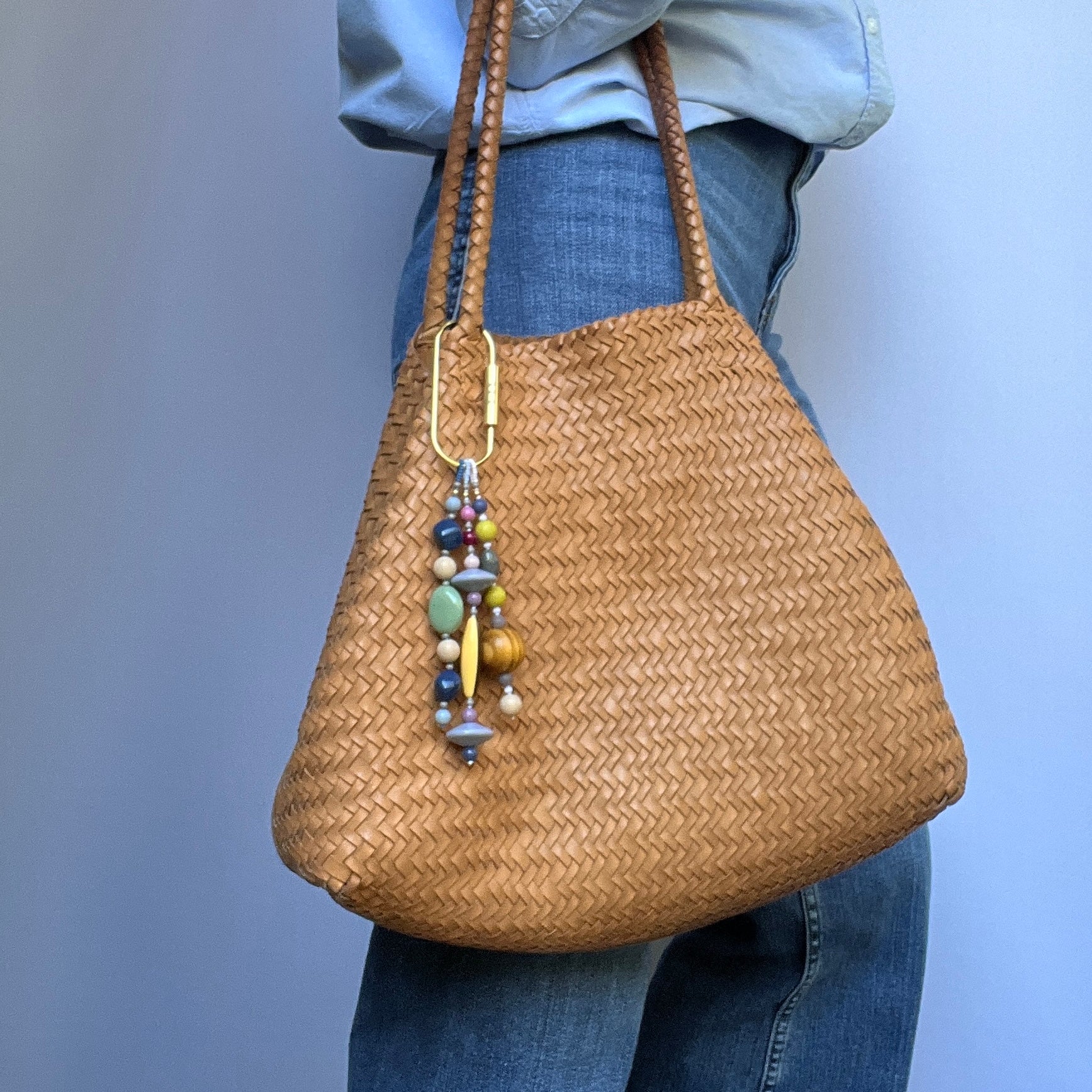 A nostalgic bag charm with a mix of textures and colors, including Czech glass beads and wooden accents, ideal for keys or bags.