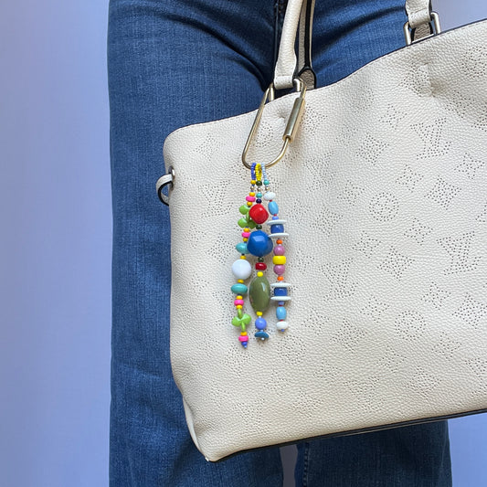 A playful bag charm with vintage glass, acrylic, and Czech glass beads, accented with 14k gold-filled findings.