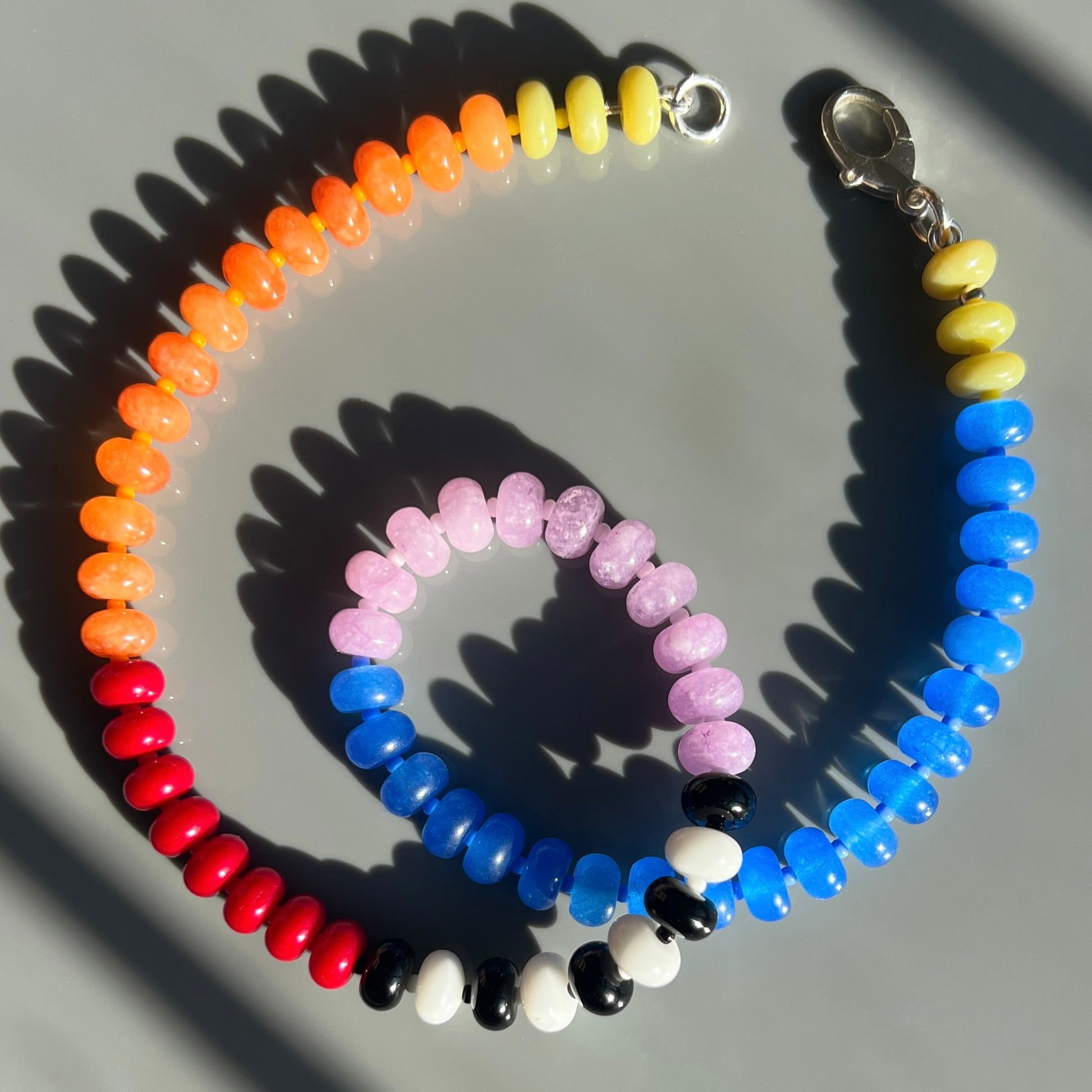 A chic and dynamic necklace crafted with jade, onyx, chalcedony, and Czech glass beads, available in sterling silver findings for a stylish touch.