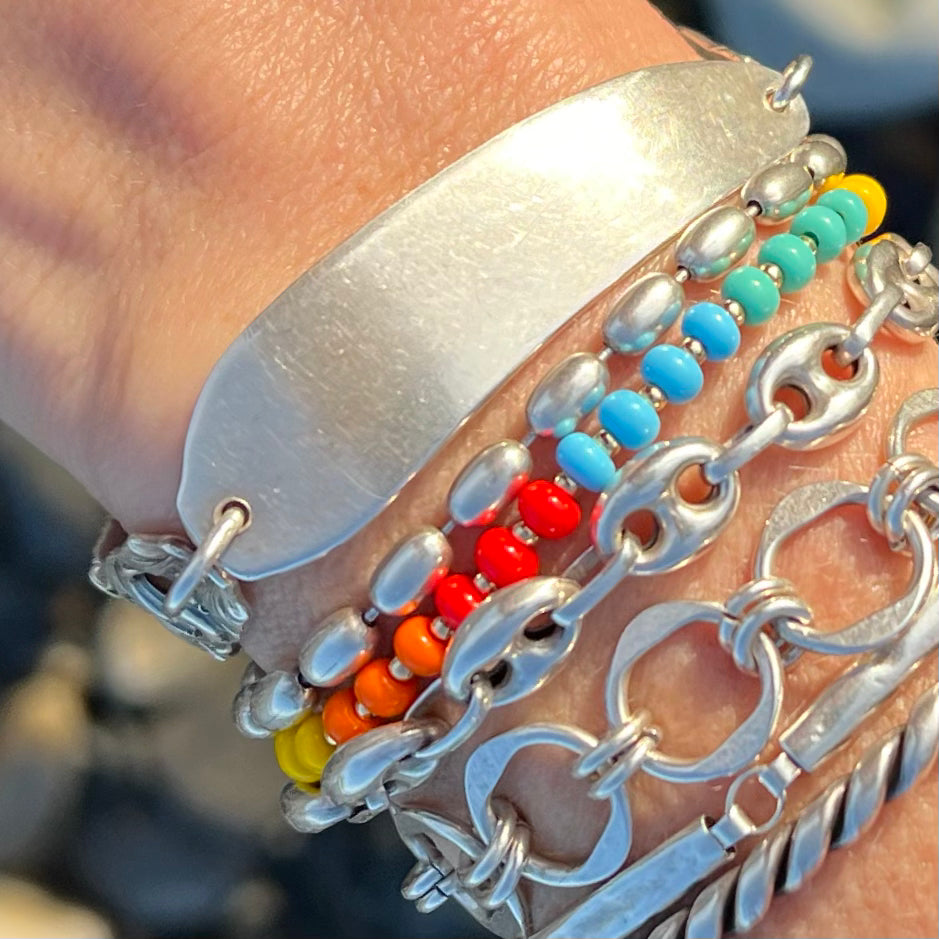Stack it or wear it solo—this handcrafted Rainbow HAPPY Bracelet blends lively rainbow hues with elegant gold-filled accents for a fun, everyday look.