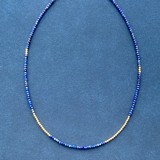 Sophisticated lapis lazuli gemstone necklace with 14K gold beads, perfect for adding a touch of refined style to any outfit.