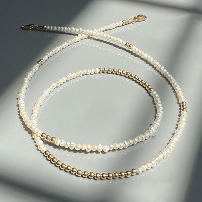 Elegant 14K gold and baroque pearl necklace, featuring hand-selected pearls and gold accents for a sophisticated, timeless design.