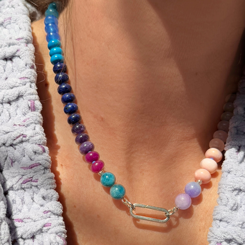 This gemstone necklace, made with Opal, Jade, Chalcedony, Howlite, and Lapis, comes with a 14K gold or sterling silver clasp, ideal for layering or making a statement on its own.