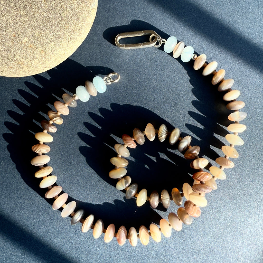 This handcrafted gemstone necklace features Botswana agate and chalcedony, finished with a 14K gold or sterling silver clasp for a refined, personalized look.