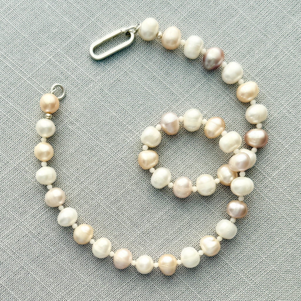 Handcrafted freshwater pearl and white coral necklace with a sterling silver or 14k gold clasp, perfect for layering or wearing alone.