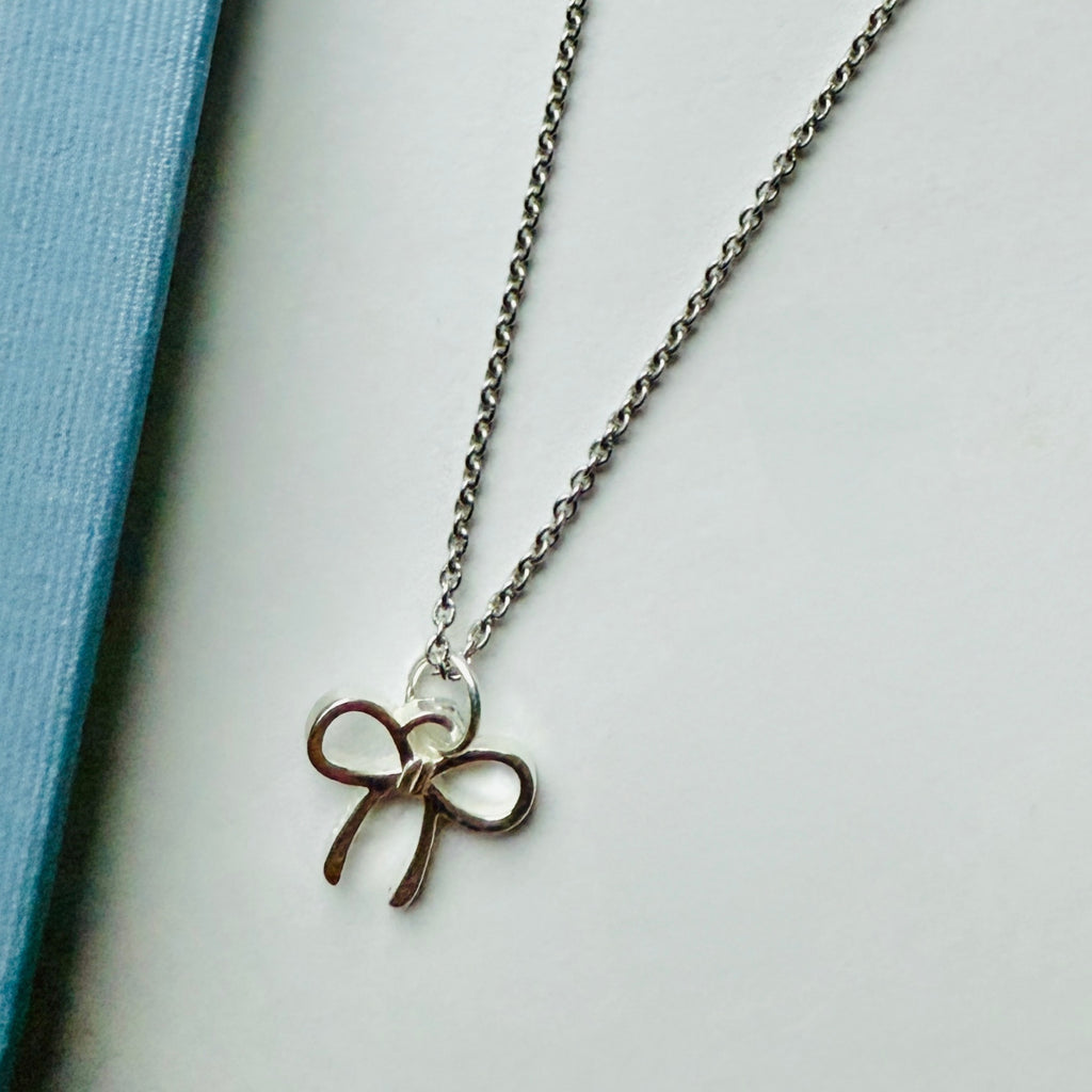 Sweet and elegant, this sterling silver bow charm measures 15mm x 15mm and makes a chic accent to any necklace or bracelet.