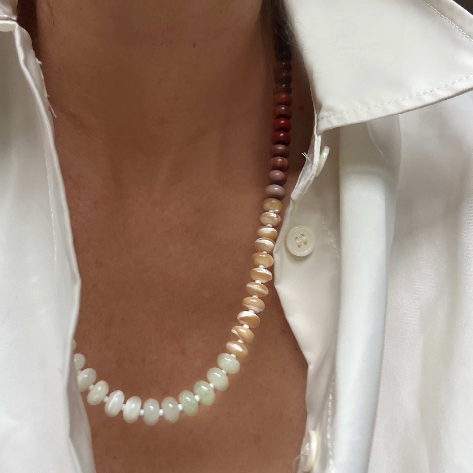 A neutral yet elegant necklace made with mother of pearl, onyx, chalcedony, and Czech glass beads, perfect for adding sophistication to any outfit.
