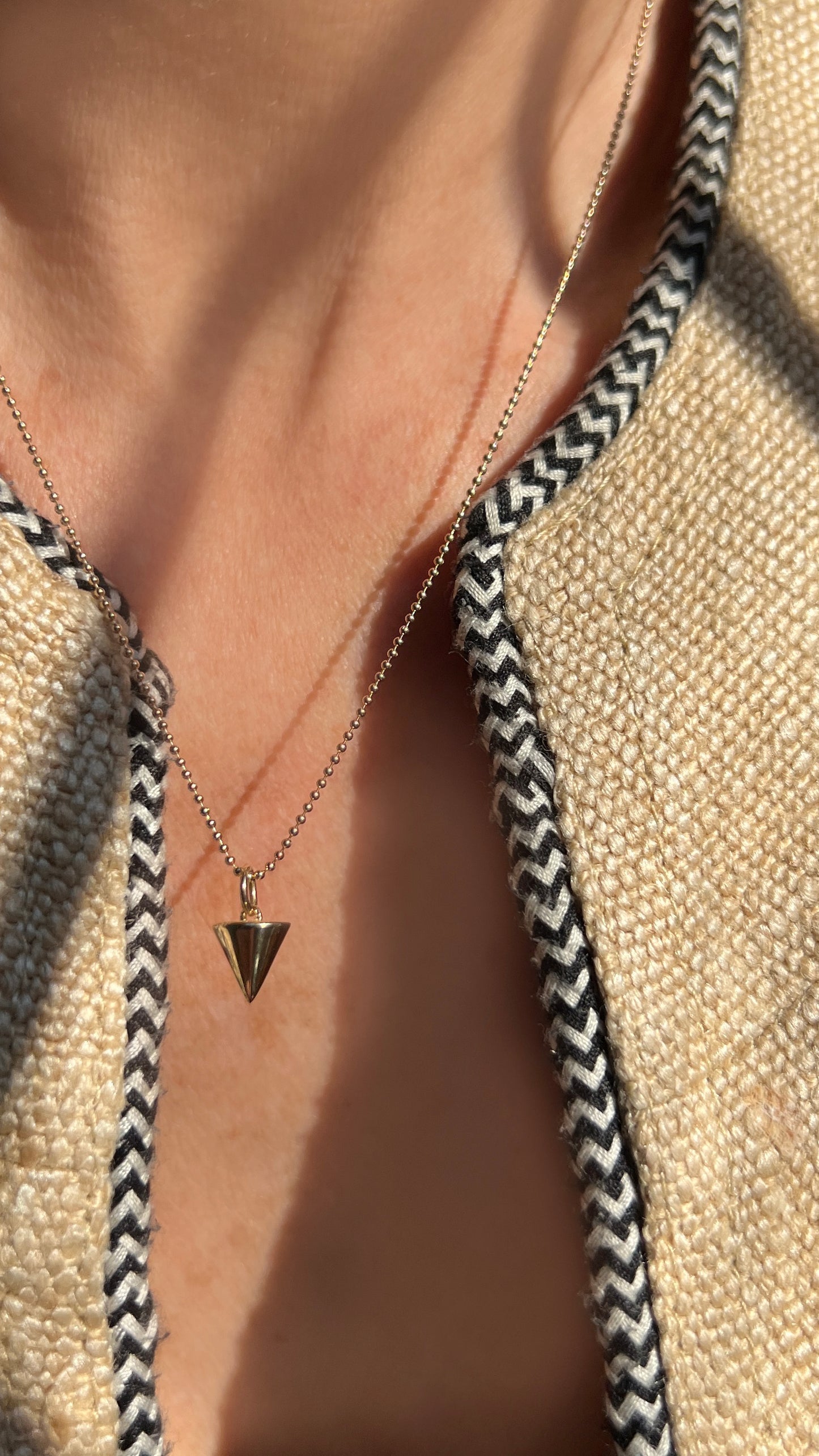 A sleek, symbolic triangle charm that represents creativity, stability, and manifestation. The Zenith Petite Necklace is available in 14K gold or sterling silver, perfect for layering or wearing solo.
