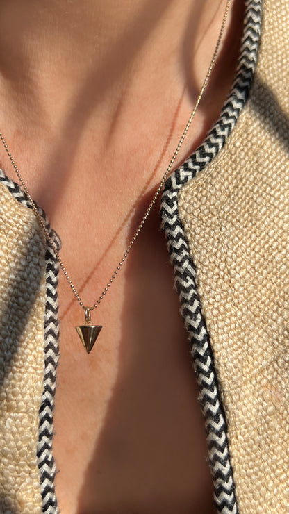 A sleek, symbolic triangle charm that represents creativity, stability, and manifestation. The Zenith Petite Necklace is available in 14K gold or sterling silver, perfect for layering or wearing solo.