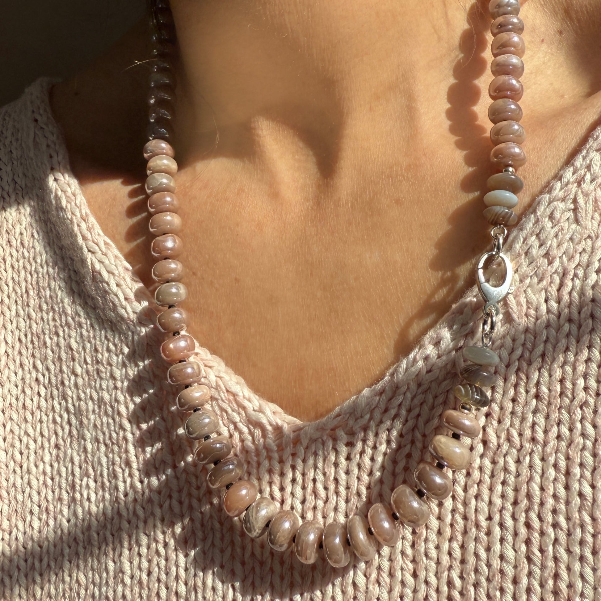 Hand-strung moonstone and agate necklace, perfect for layering or wearing solo. Features unique gemstones and sleek silver clasp and findings, adding a touch of sophistication to any outfit