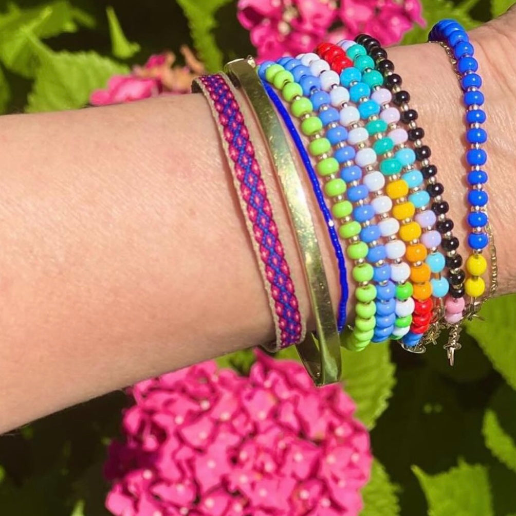 A unique blend of soft periwinkle and striking red, this HAPPY Bracelet is finished with gold-filled accents for a stylish and durable design.