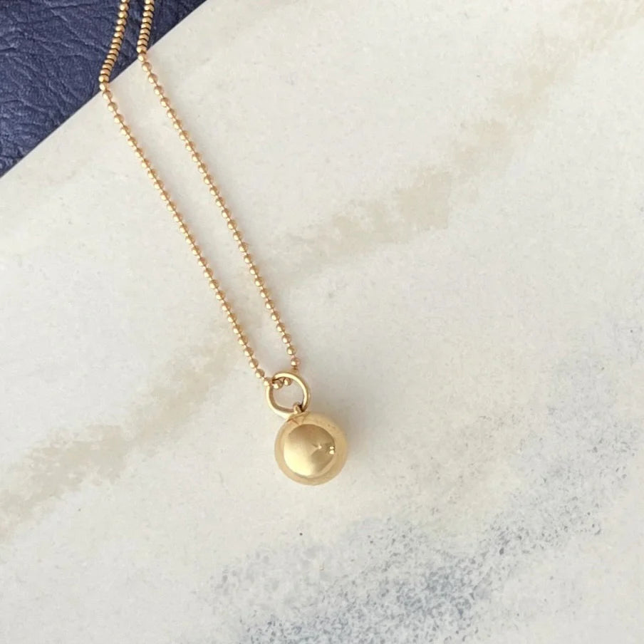 Hand-carved and cast in 14K gold, the Sphere Pendant represents unity and balance, offering both meaningful design and durability for daily use.