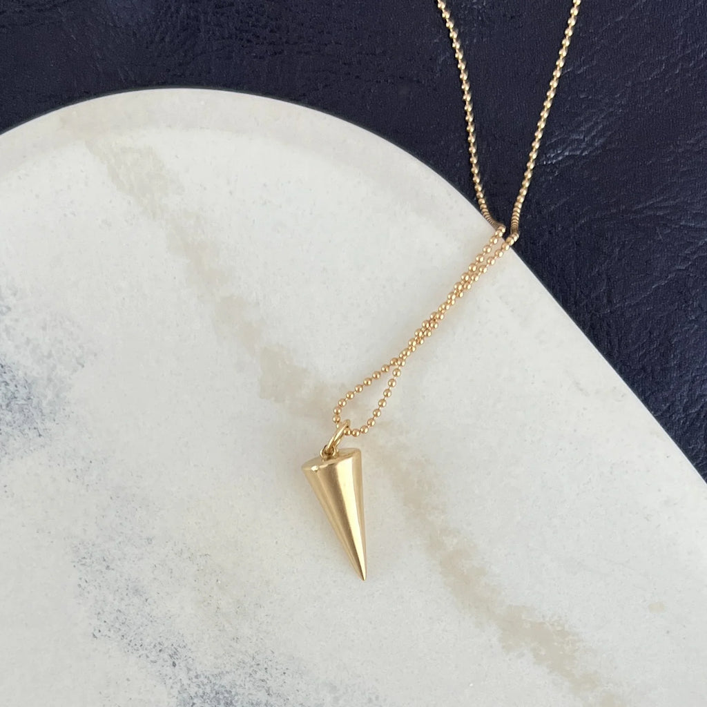 A grounding emblem of renewal and balance, the Zenith Necklace's downward-pointing triangle symbolizes femininity and life’s interconnected cycles, crafted in 14K gold or sterling silver.