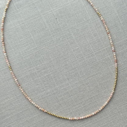 Faceted pink opal beads paired with 14K gold, creating a luxurious and timeless necklace that can be worn alone or layered for added flair.