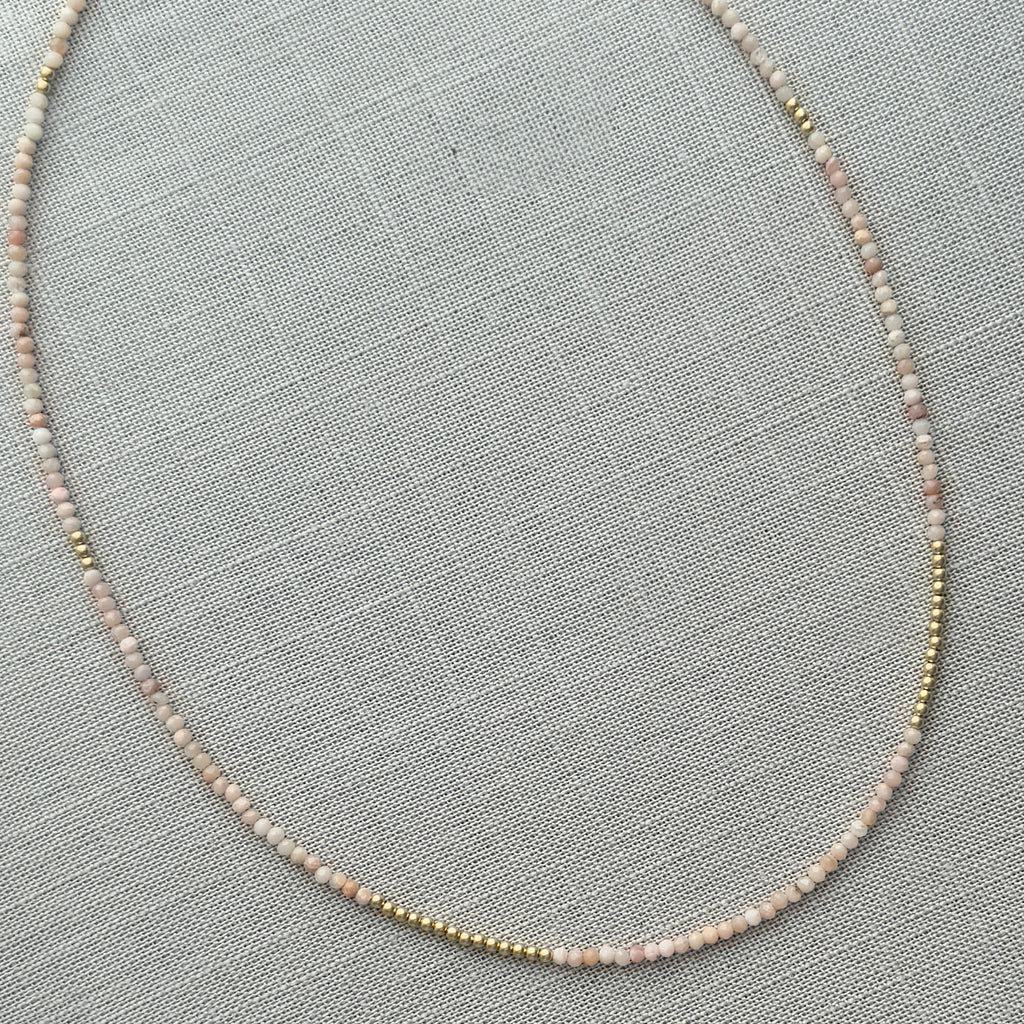 Faceted pink opal beads paired with 14K gold, creating a luxurious and timeless necklace that can be worn alone or layered for added flair.