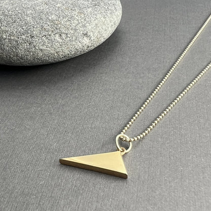 The Scalene Triangle Pendant, with its asymmetrical design, celebrates individuality and authenticity, crafted from solid 14K gold or sterling silver.