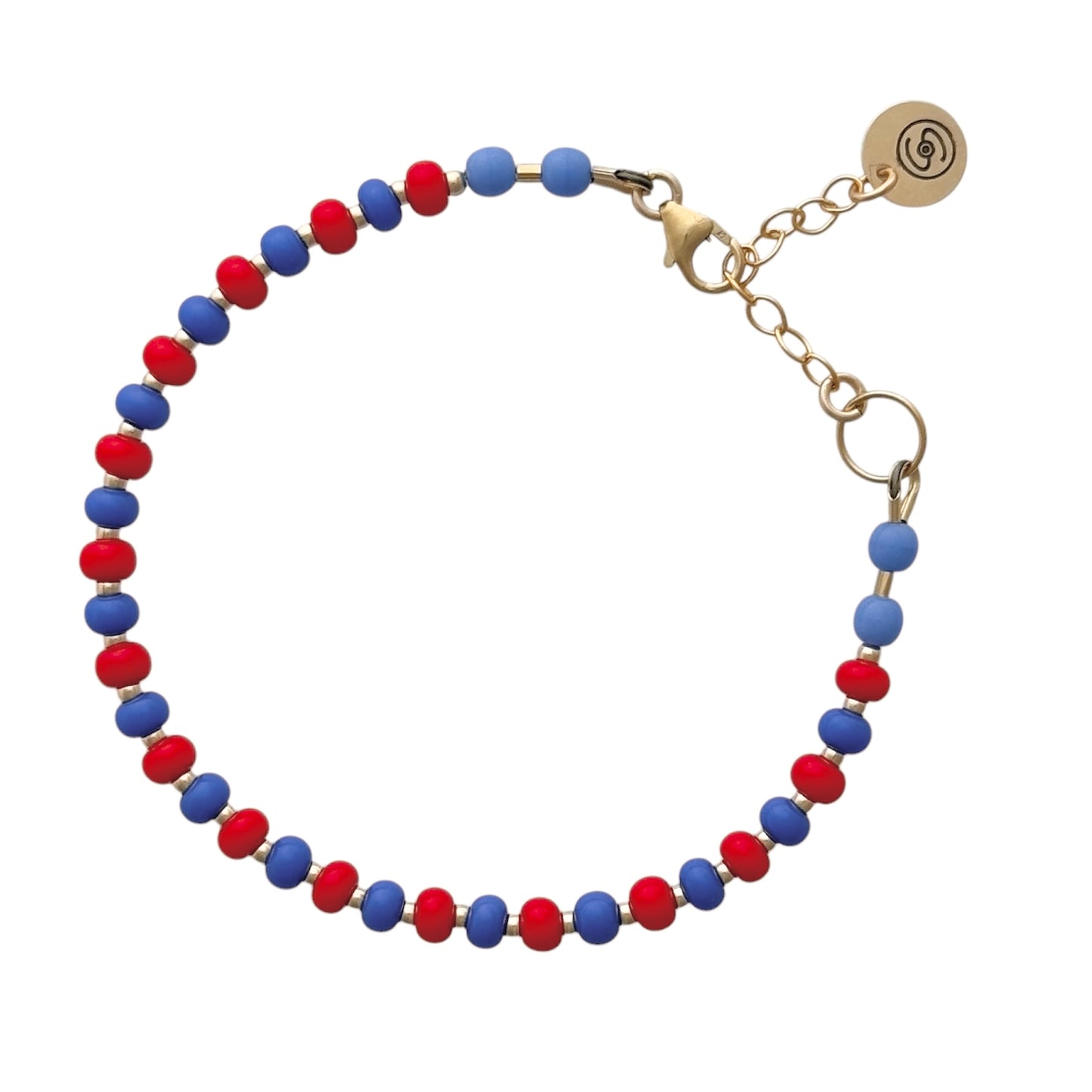 Hand-strung with high-quality Czech glass beads, the Periwinkle + Red HAPPY Bracelet adds a playful yet elegant touch to any outfit.