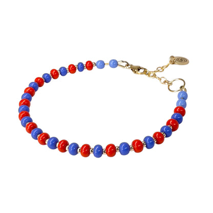 The Periwinkle + Red HAPPY Bracelet features a vibrant mix of bold red and soft periwinkle Czech glass beads, accented with 14K gold-filled details.
