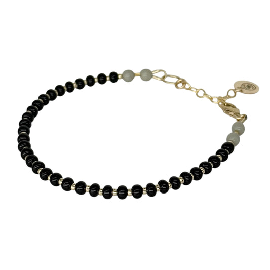 The Midnight Black + Gray HAPPY Bracelet features sleek Czech glass beads in deep black and soft gray, accented with luxurious 14K gold-filled details.