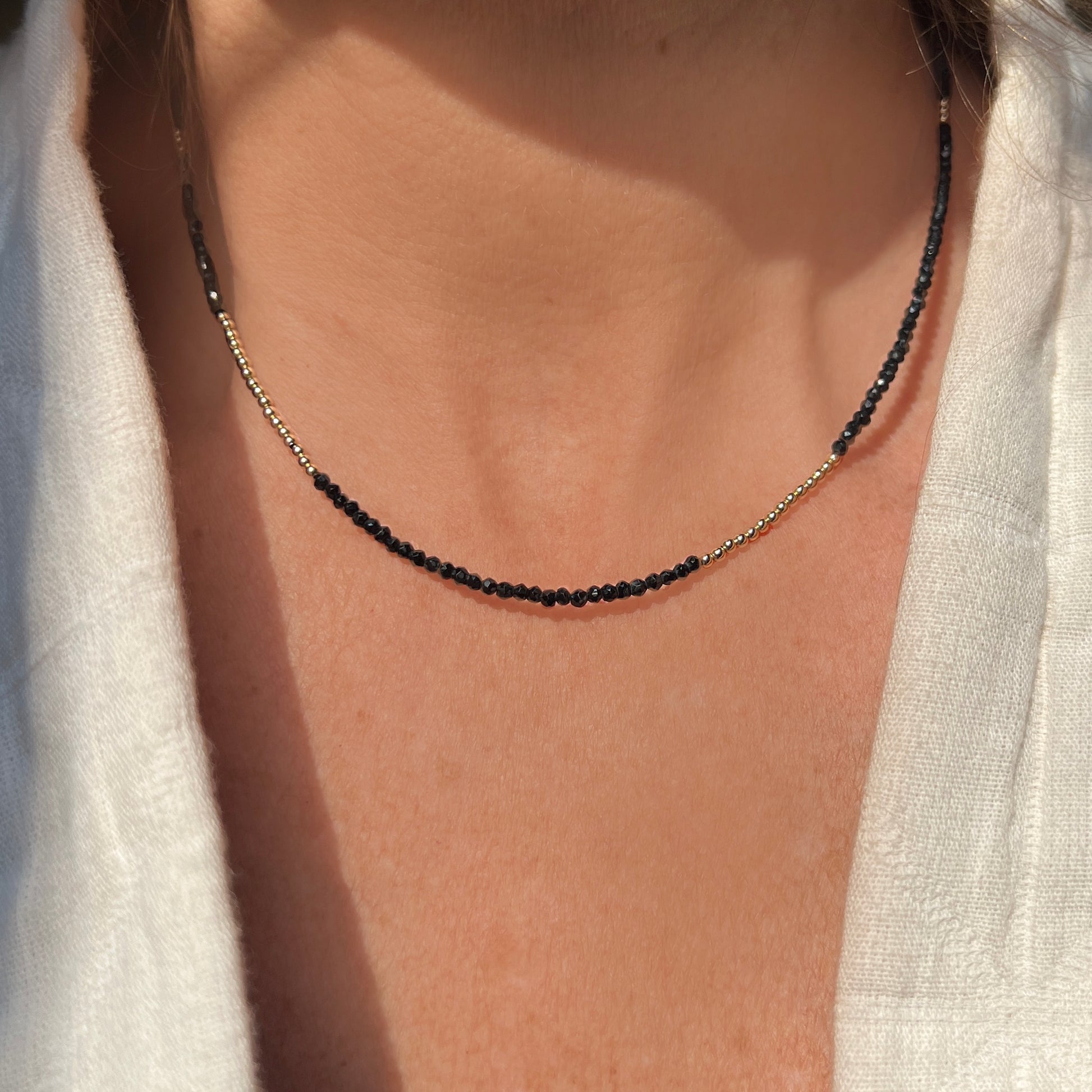 Dazzling black spinel gemstone necklace with 14K yellow gold accents, offering a refined, fashion-forward look for any occasion.