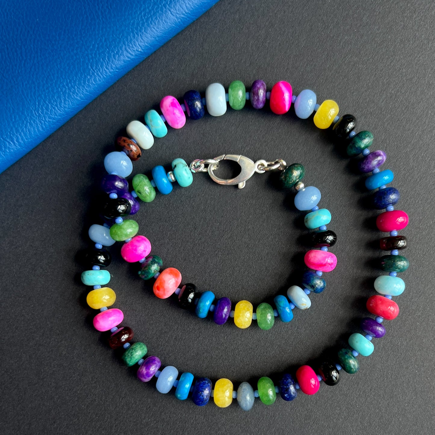 Handcrafted gemstone necklace with vibrant 8mm opals, moonstone, jasper, jade, howlite, chrysocolla, chalcedony, turquoise, onyx, and tiger eye, accented with Czech glass beads and a sterling silver clasp.