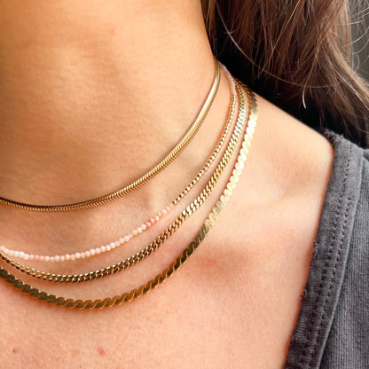 Luxurious pink opal gemstone necklace with 14K yellow gold beads and findings, designed for a subtle hint of elegance.